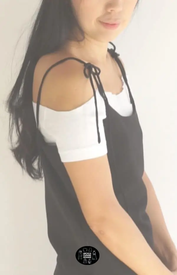 Sideview of the black DIY silk slip dress with a white off the shoulder top underneath.