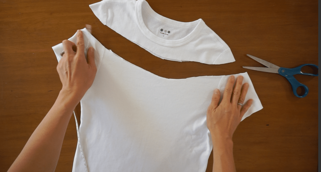 Cut the new neckline to make an off the shoulder top from a t-shirt.