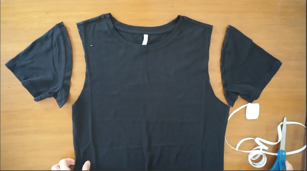 Cut along the line to remove the sleeves and create a tank top.