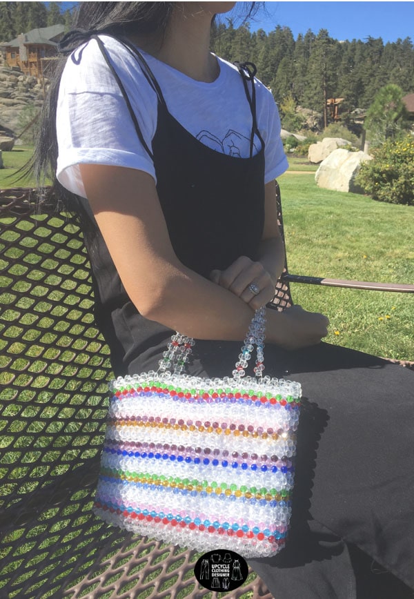 Beaded purse with a colorful stripe pattern.