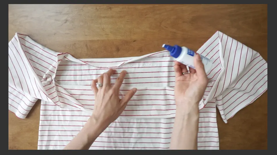 Hem the neckline of the off shoulder t-shirt using fabric glue.