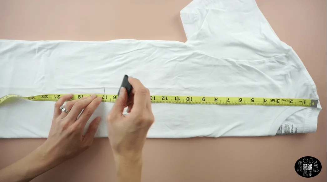 Fold the t-shirt in half lengthwise. Mark 17" down from the high point on the shoulder seam.