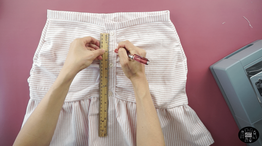 Add a new button to the waistband and a few extra button to the button placket. Use a ruler to measure the new placement.