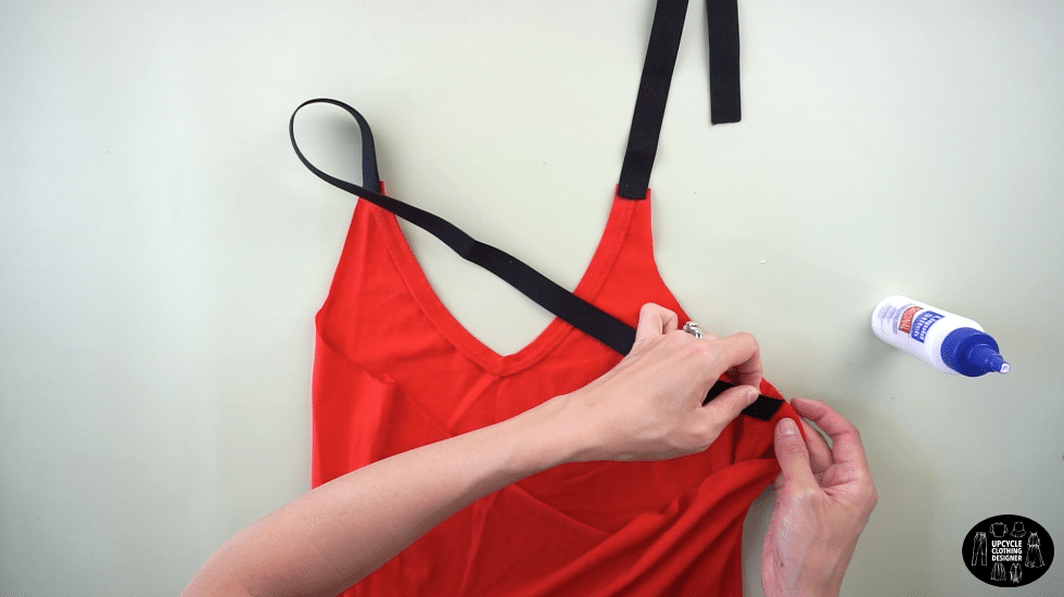 Use fabric glue to join the other end of the shoulder strap to the side seam just underneath the new armhole opening.