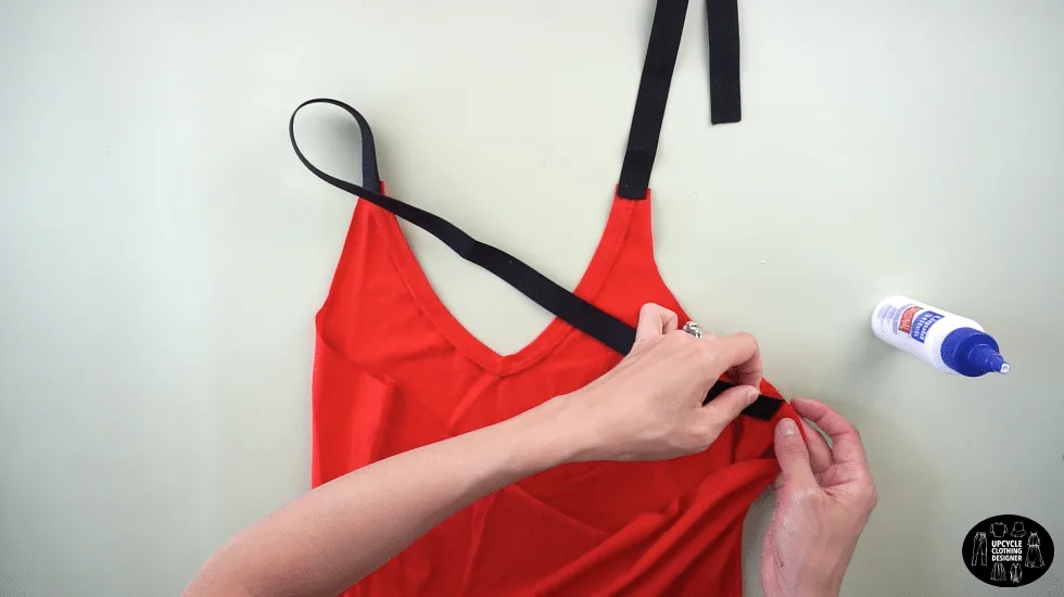 Use fabric glue to join the other end of the shoulder strap to the side seam just underneath the new armhole opening.