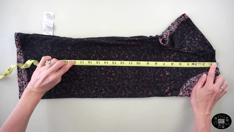 Flip the tee inside out and fold in half lengthwise. Measure 18" down from the high point on the shoulder