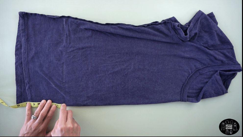 Flip the tee inside out and fold it in half lengthwise.
