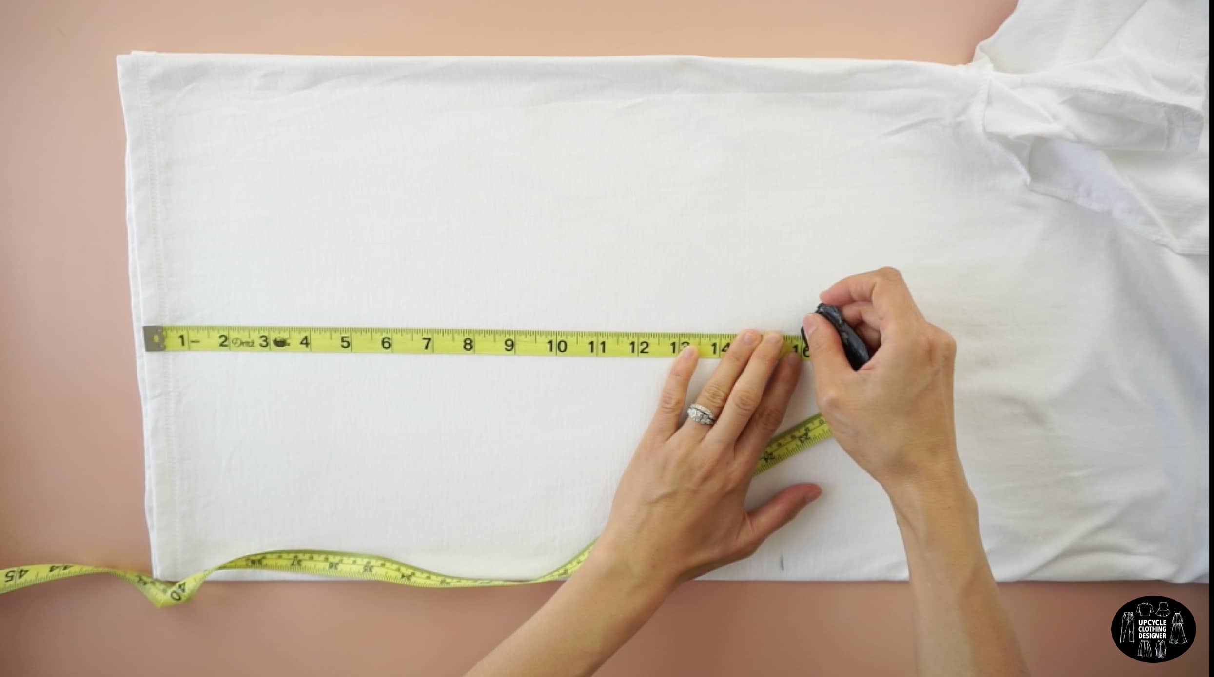 Fold the tee in half lengthwise. Measure 16" up from the bottom hem