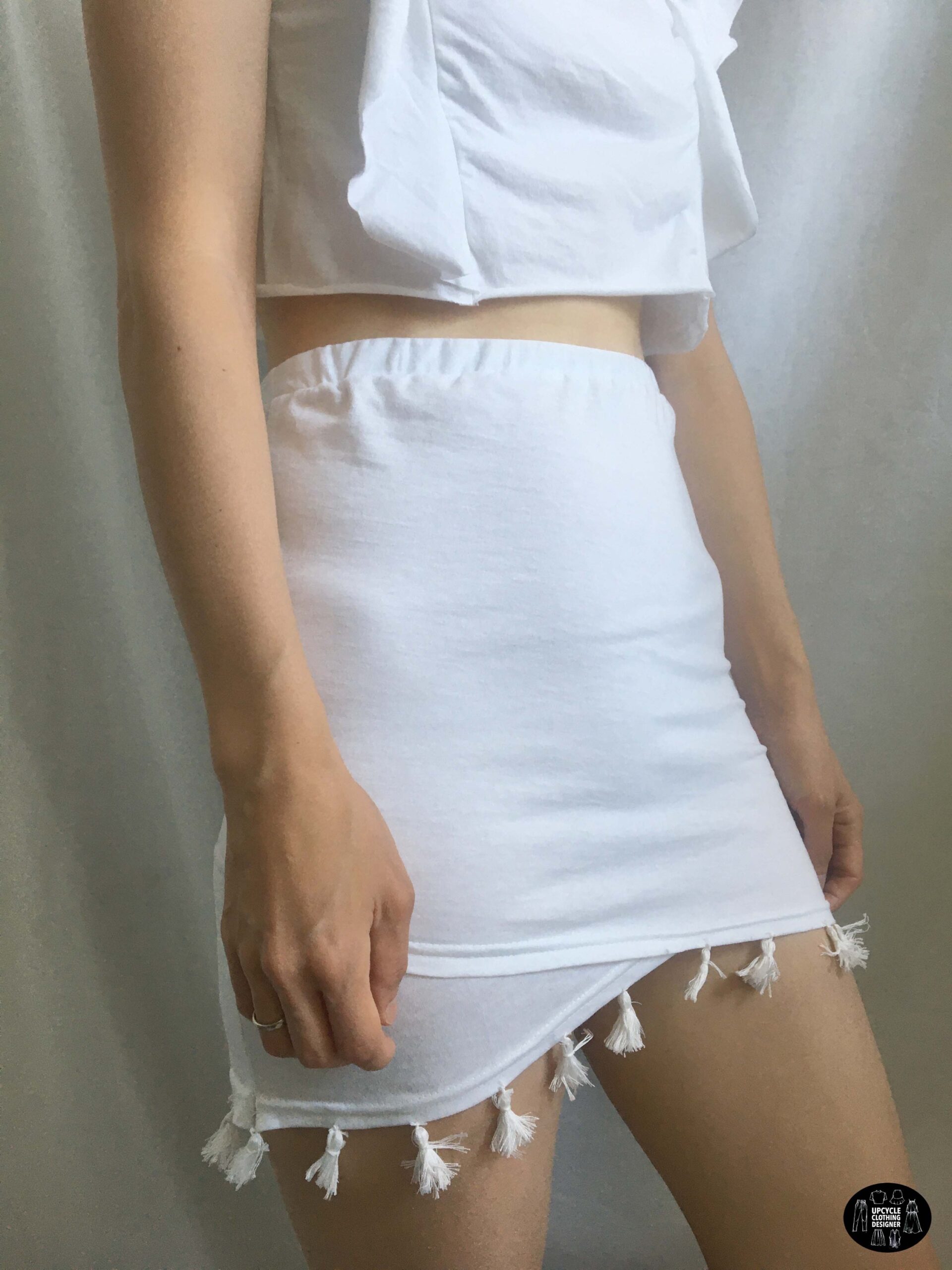 Sideview of the tassel trim mini skirt from a t-shirt