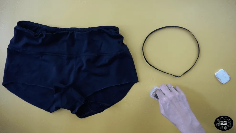Overlap the ends of the elastic band to make loop for the leg opening on the swimsuit bottom.