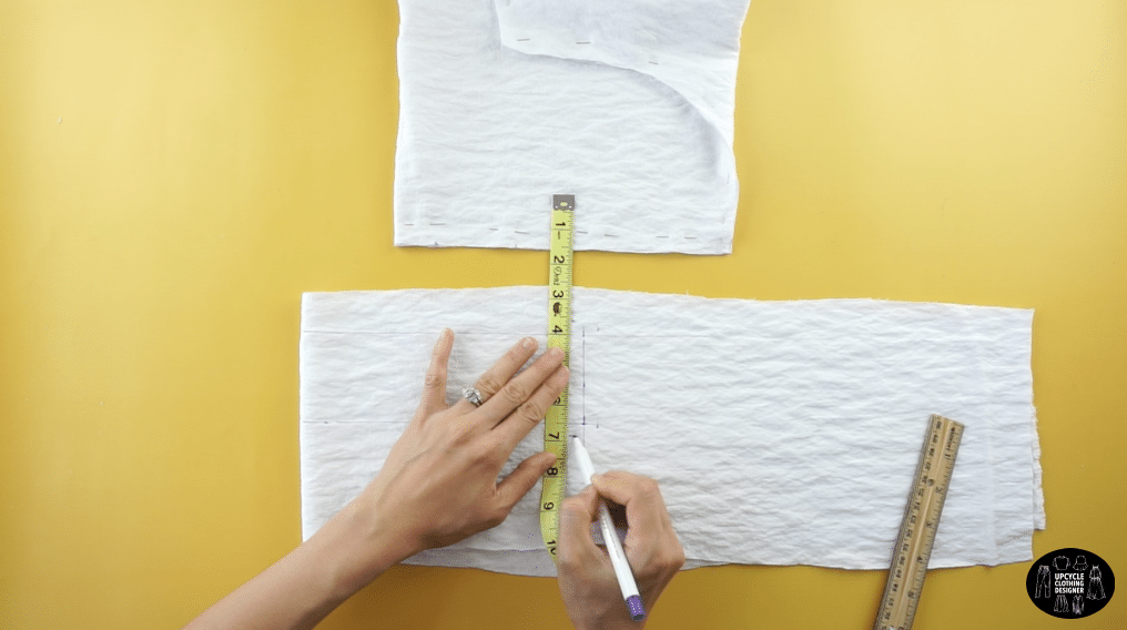 To make the back waistband, fold a piece of fabric in half. Draw a straight line across the top edge. Mark 2½” down the fold edge, and then draw line parallel to the top edge.