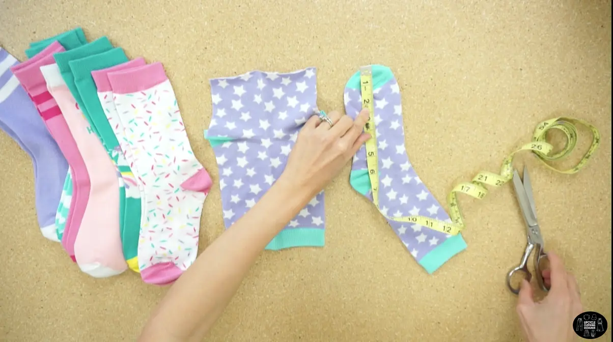 Grab a bunch of colorful socks. Remove the toes by cutting them off about 2” away from the tip. 