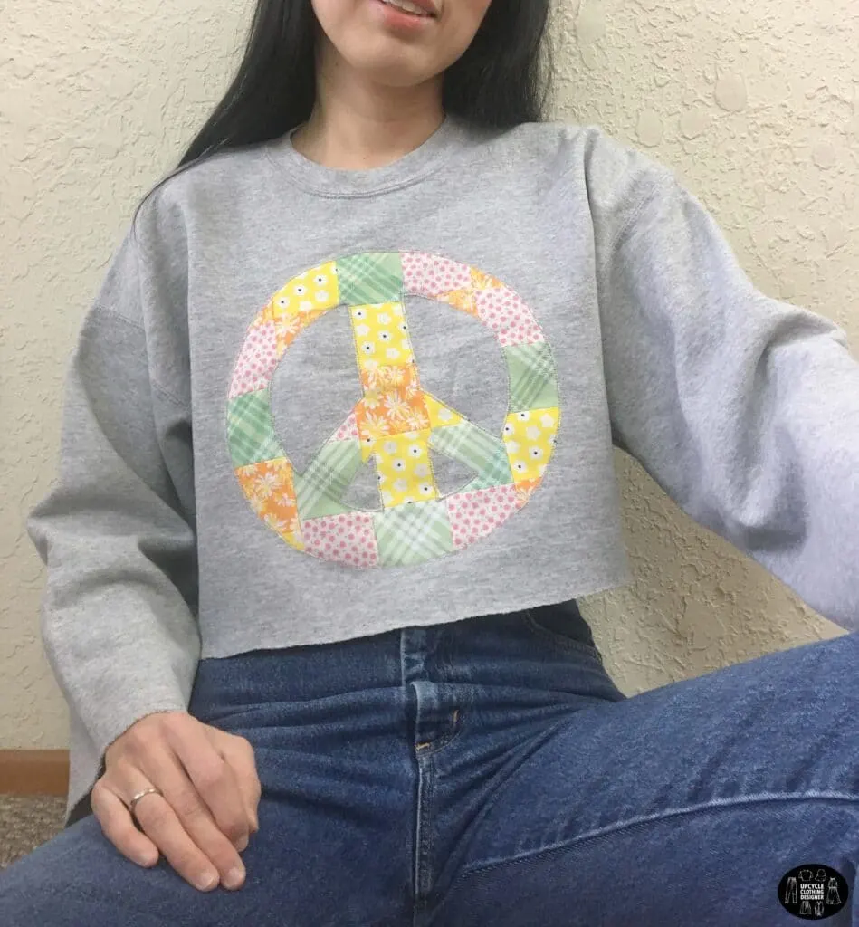 Patchwork peace sign cropped sweatshirt front closeup Patchwork peace sign cropped sweatshirt front closeup