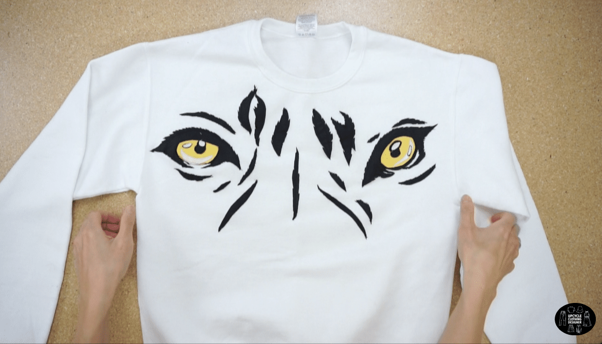 Finished tiger eye applique design on white sweatshirt