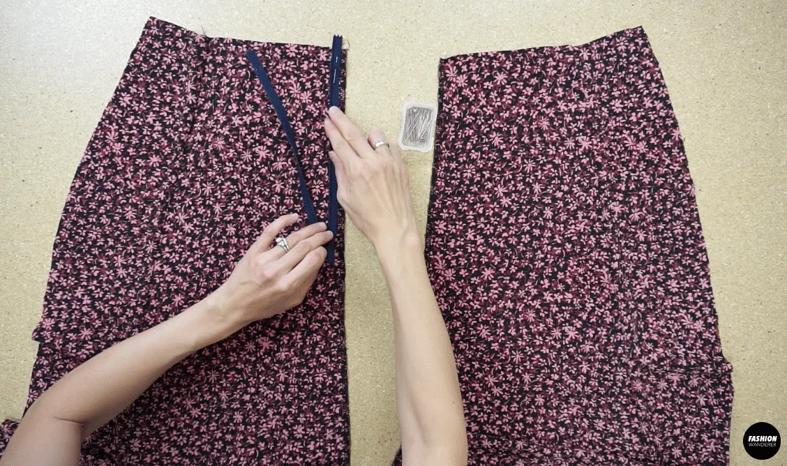 To attach a zipper to the back of the dress, open the zipper and join the placket tape to the center back opening starting at the waistline on both sides.