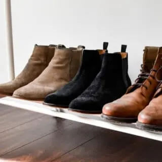 brown and black suede boots on the clothing rack