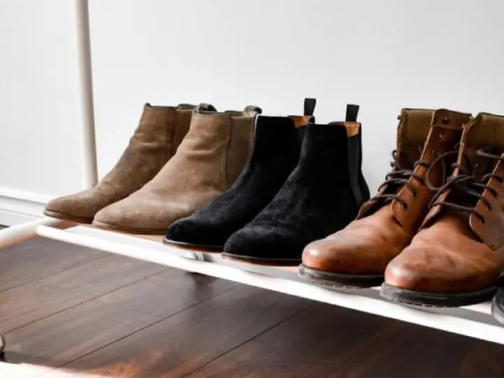 brown and black suede boots on the clothing rack