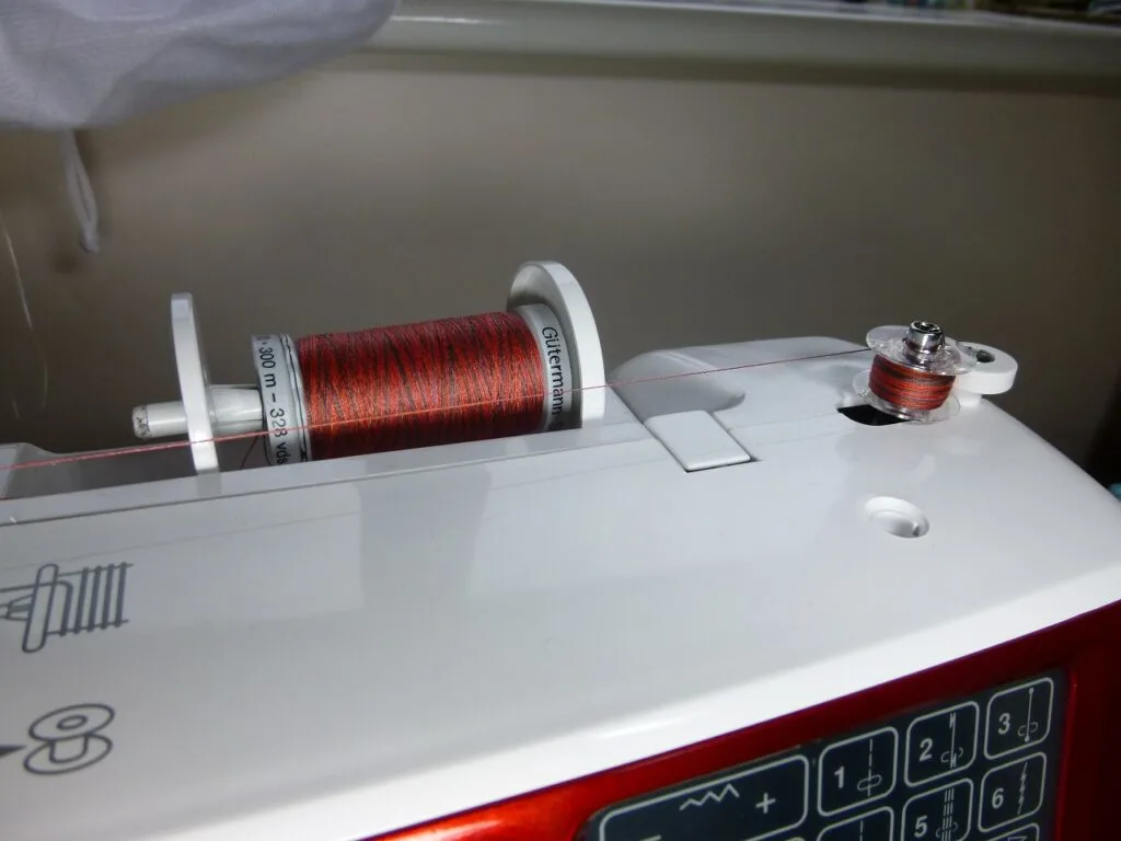 spool of thread on a sewing machine spool of thread on a sewing machine