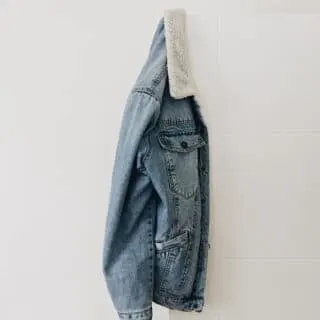 sherpa denim jacket hanging on the wall