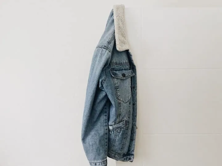 sherpa denim jacket hanging on the wall