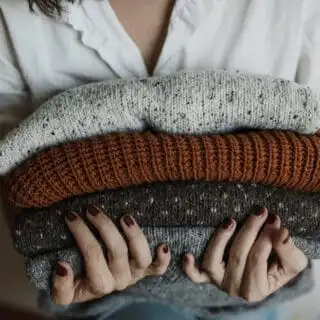 holding shrinked sweaters