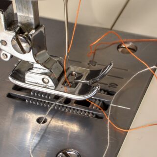 thread tangled around a sewing machine foot