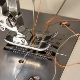 thread tangled around a sewing machine foot