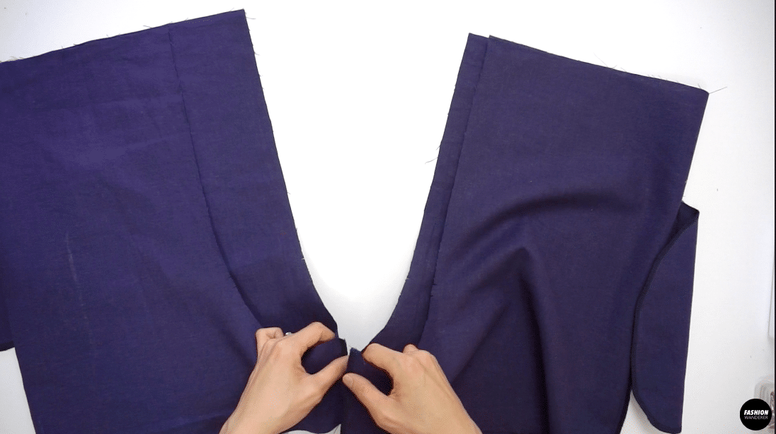 To sew shorts, close the inseam with ⅜” seam allowance on both legs and overlock the raw edges together to prevent the fabric from fraying. Press the seams flat folding the overlocked edges toward the back of the shorts.