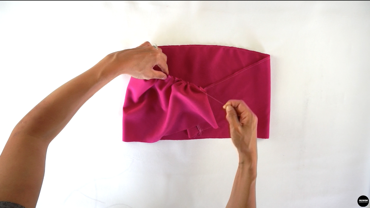 Gently, pull one of the threads to evenly distribute the shirring along the sleeve