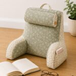 Handmade floral reading pillow with cushioned back support, armrests, side pocket and handle, a cozy sewing project for reading and homework.